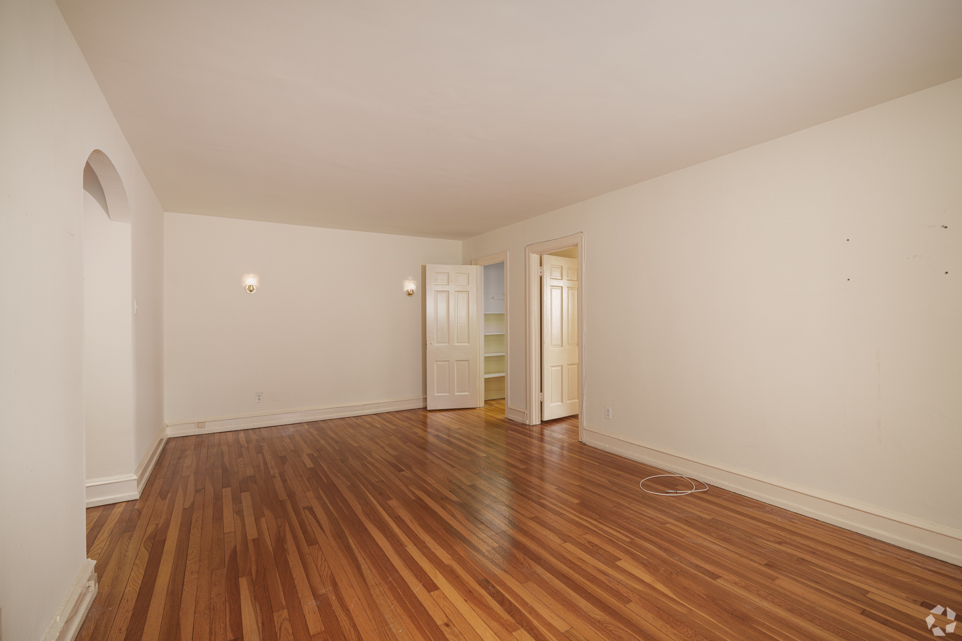 A room with wooden floors and white walls.